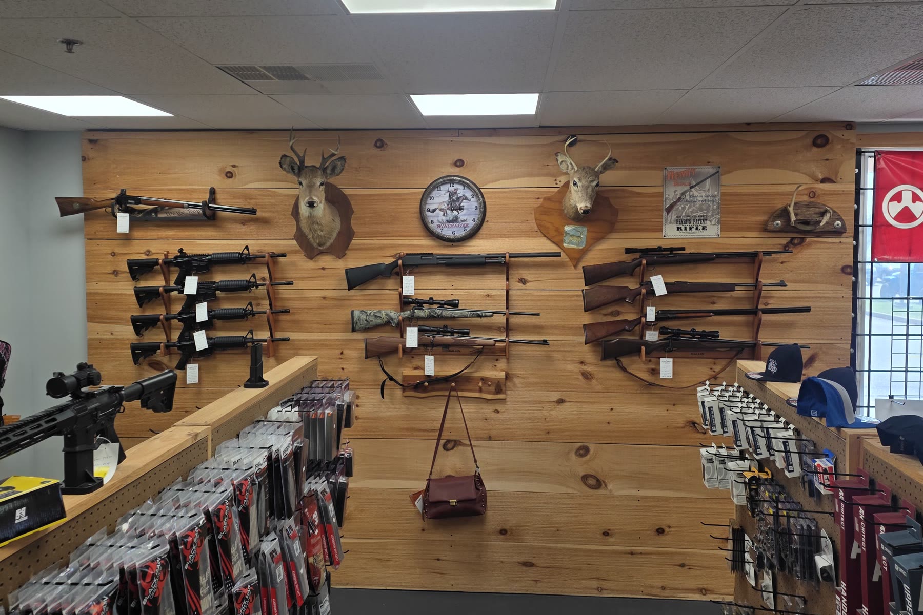 The heritage wall at the Martinsburg store: hunting rifles and deer mounts