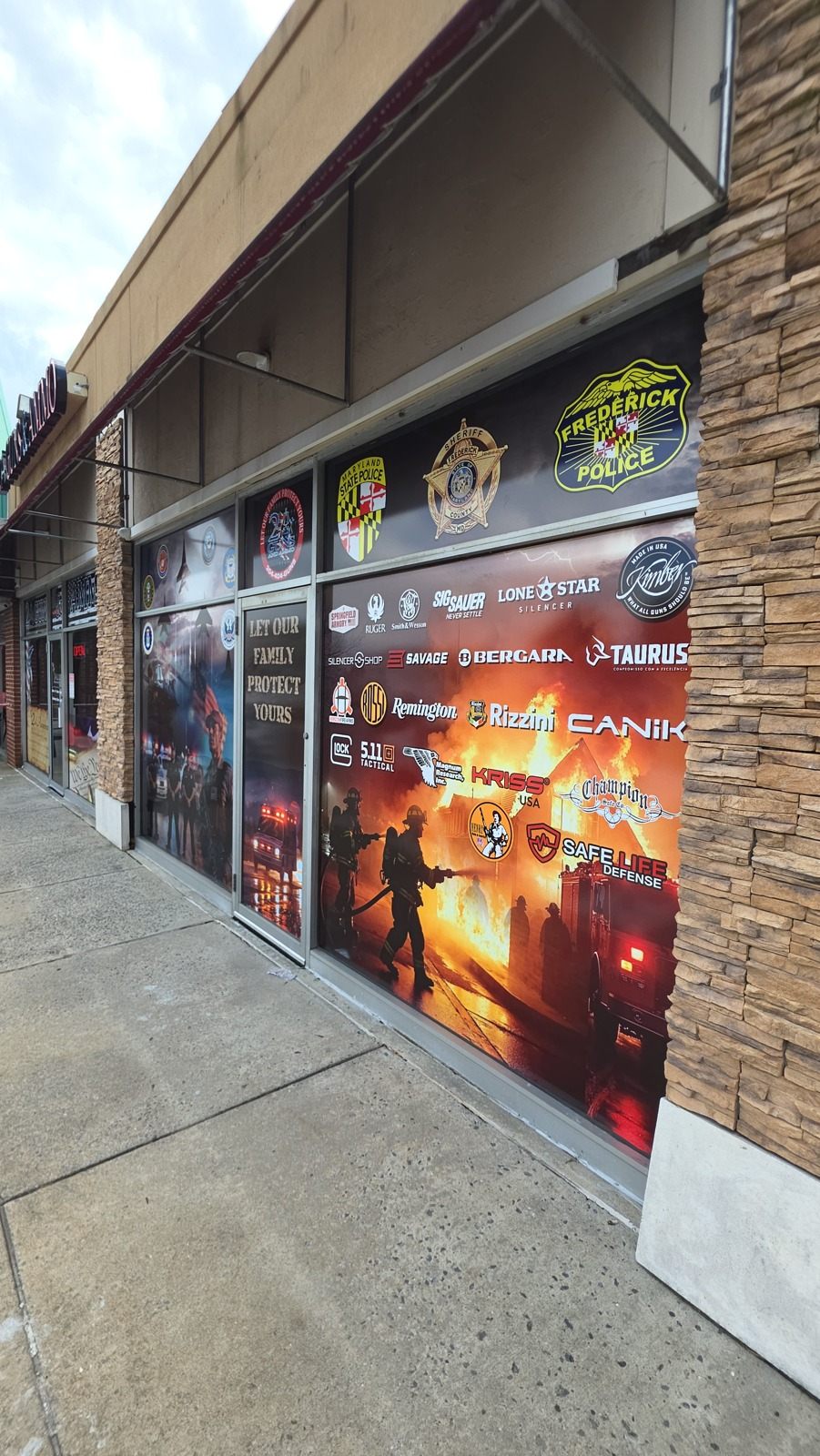 The Frederick storefront windows with brand logos and first-responder badges