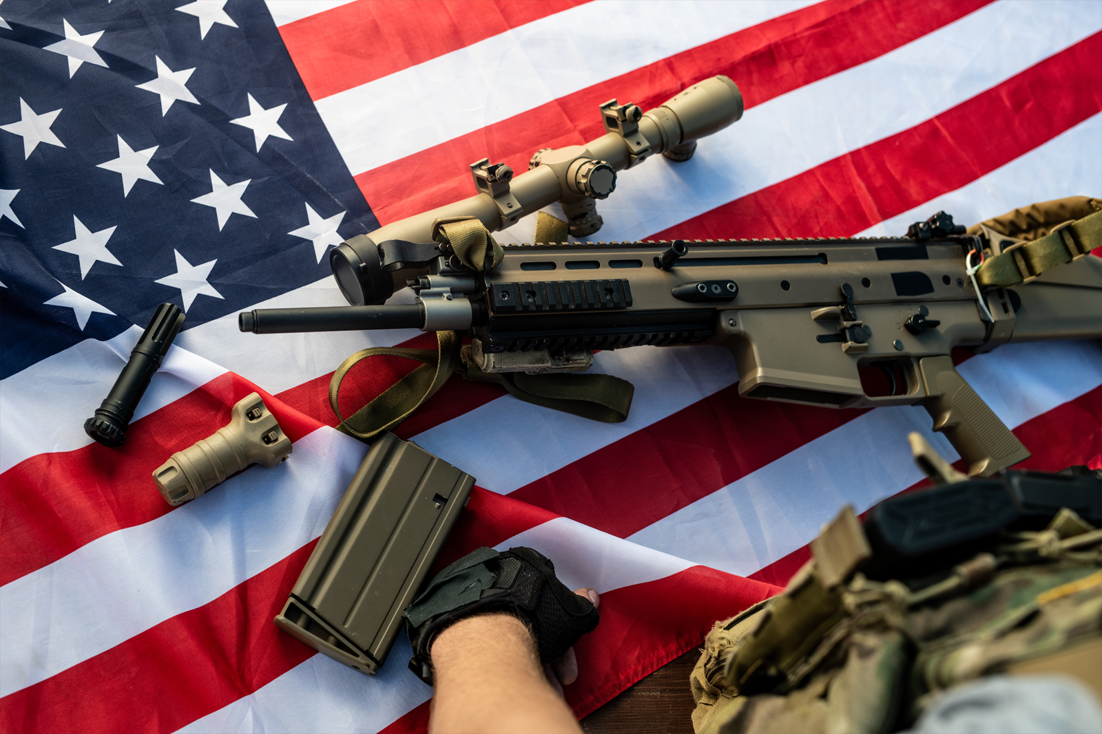 man in black and brown camouflage jacket holding black assault rifle